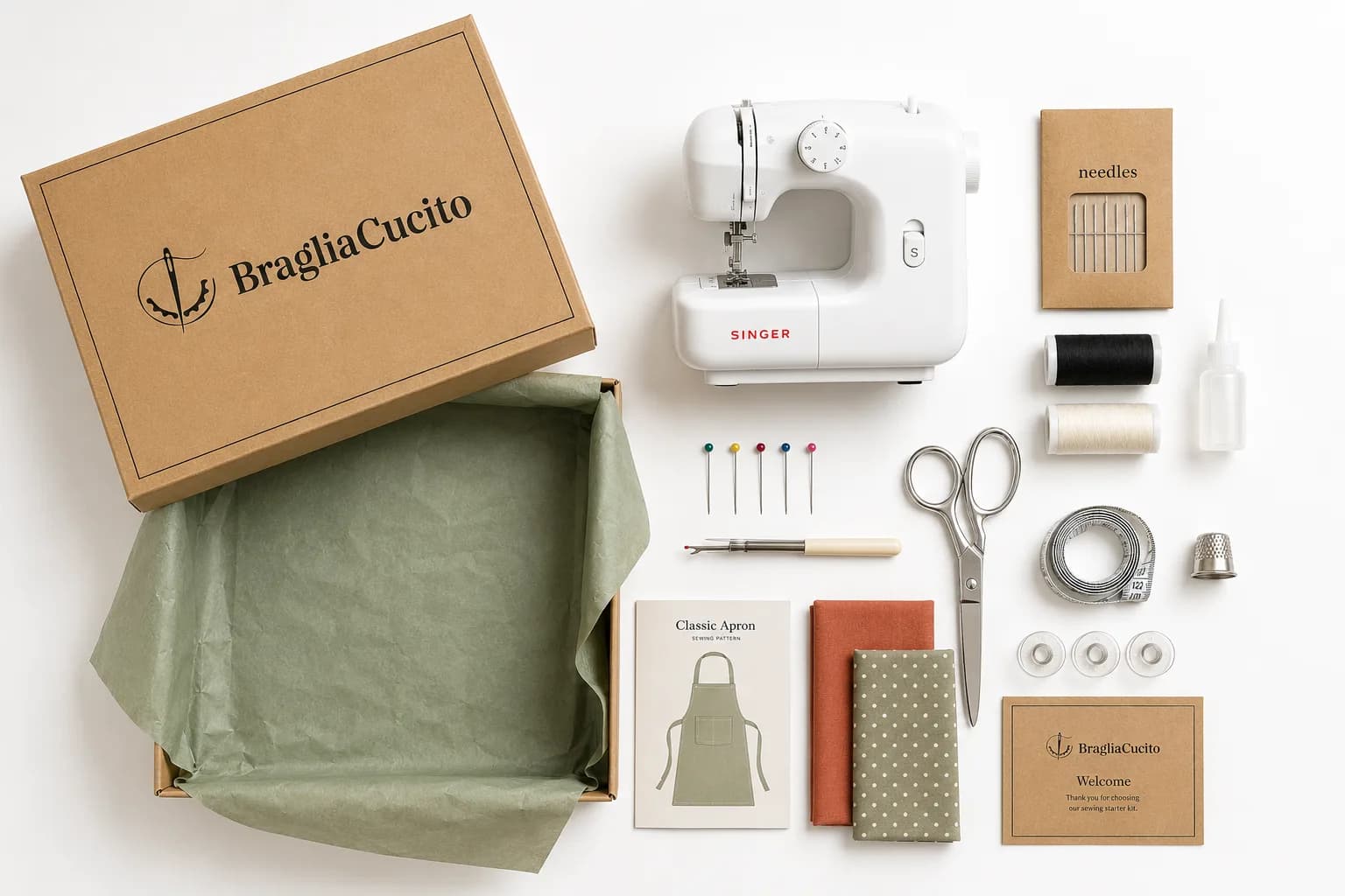 Everything inside The Sewing Kit laid out: machine, needles, thread, scissors, fabric, pattern and tools
